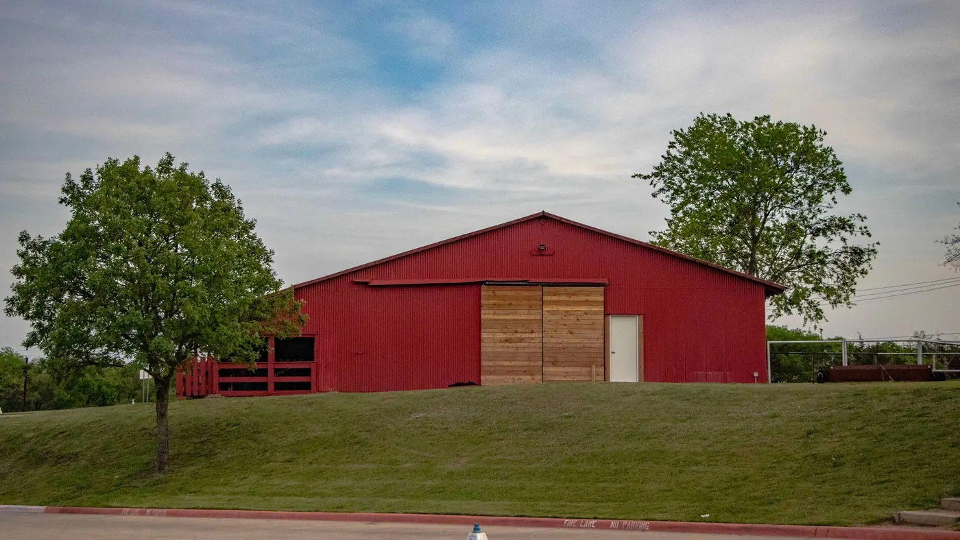 Red barn on a grassy hill in Allen, Texas