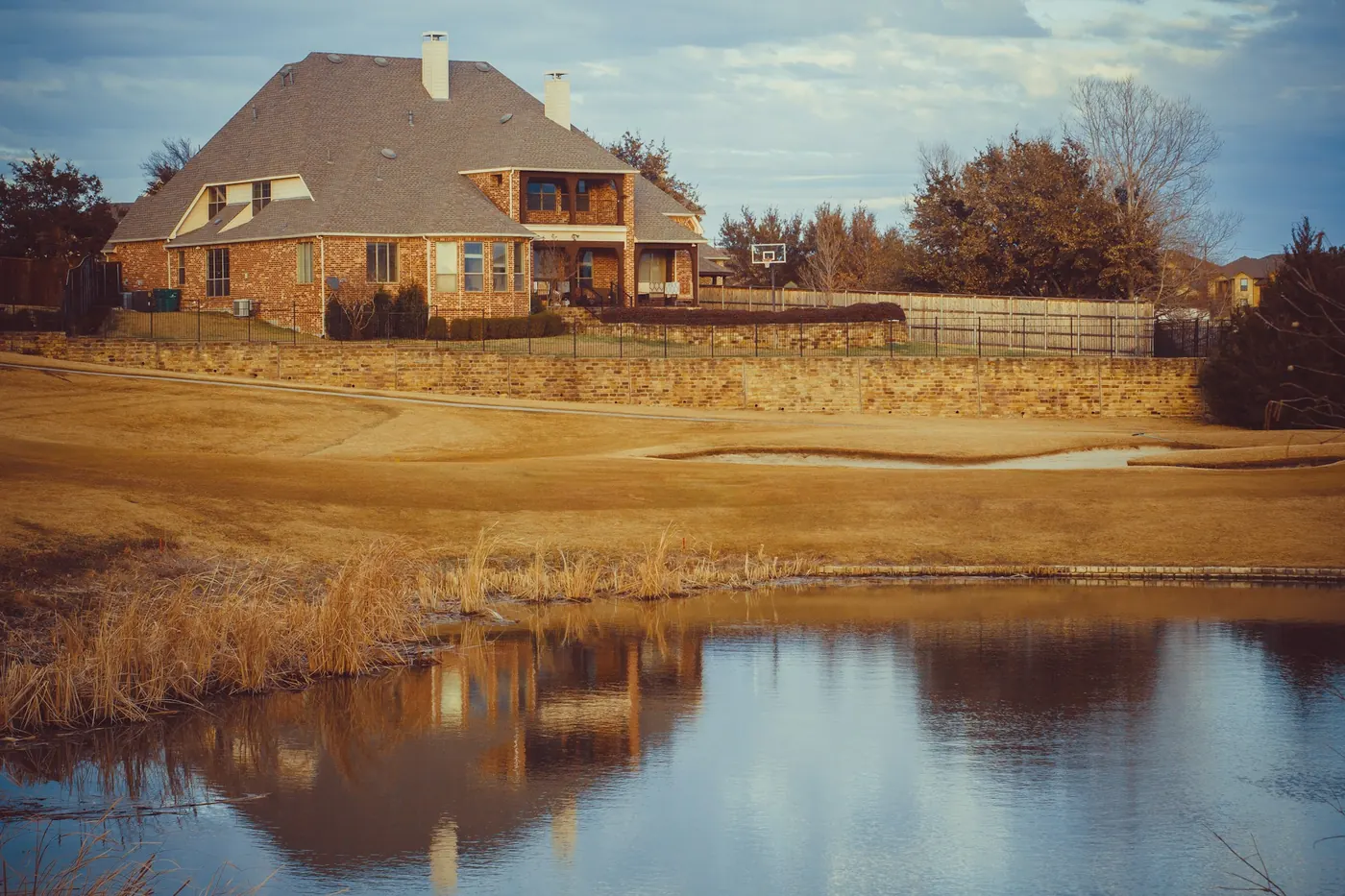 Brick home beside a pond in Carrollton, Texas