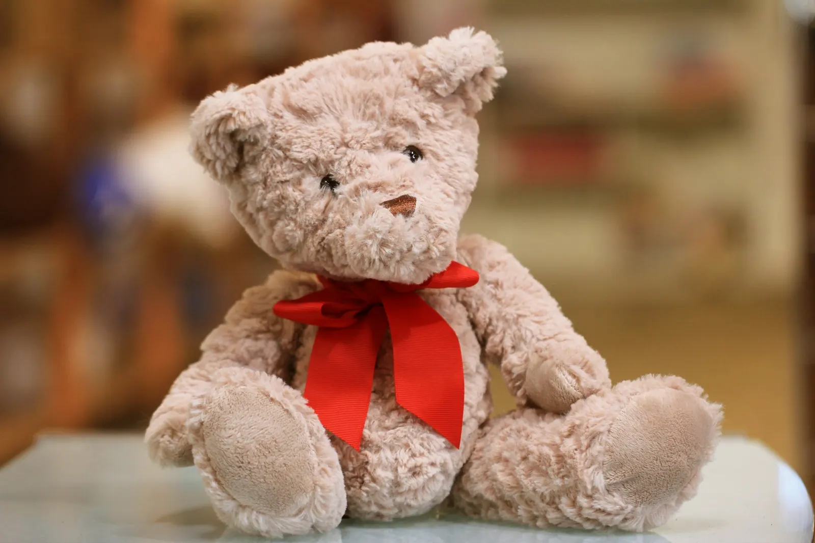 Soft teddy bear with a red bow