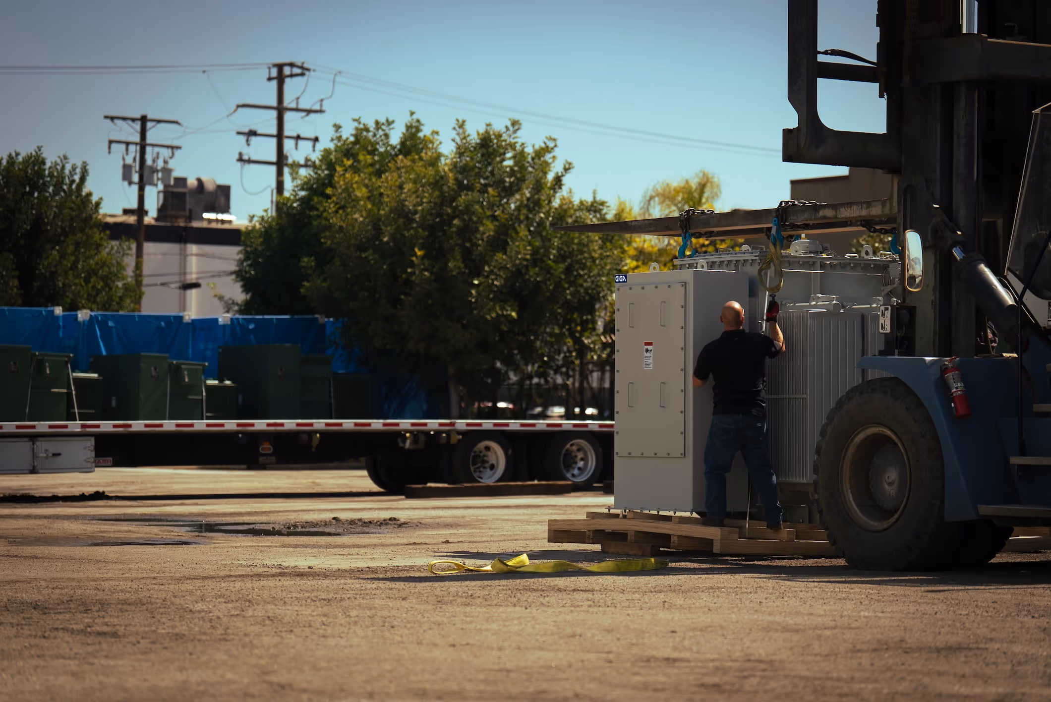 man working on giga equipment outside