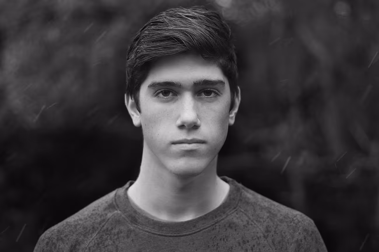 Black and white portrait of a young person with serious expression