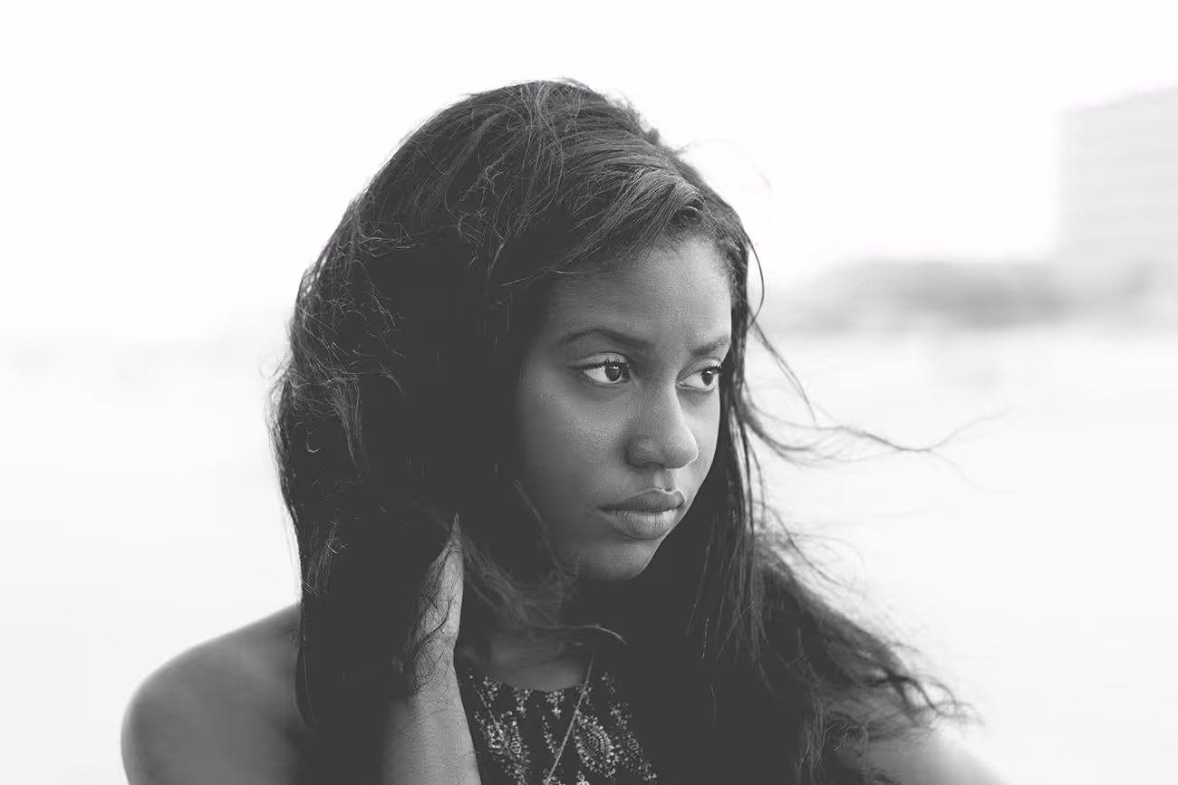 Black and white portrait of a woman with windblown hair looking sideways