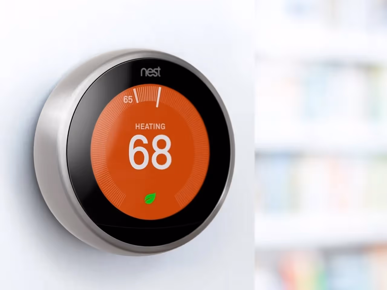 Nest smart thermostat displaying heating temperature at 68 degrees.