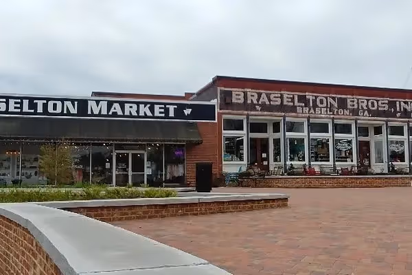 Brick storefronts of Selton Market and Braselton Bros. with brick walkway