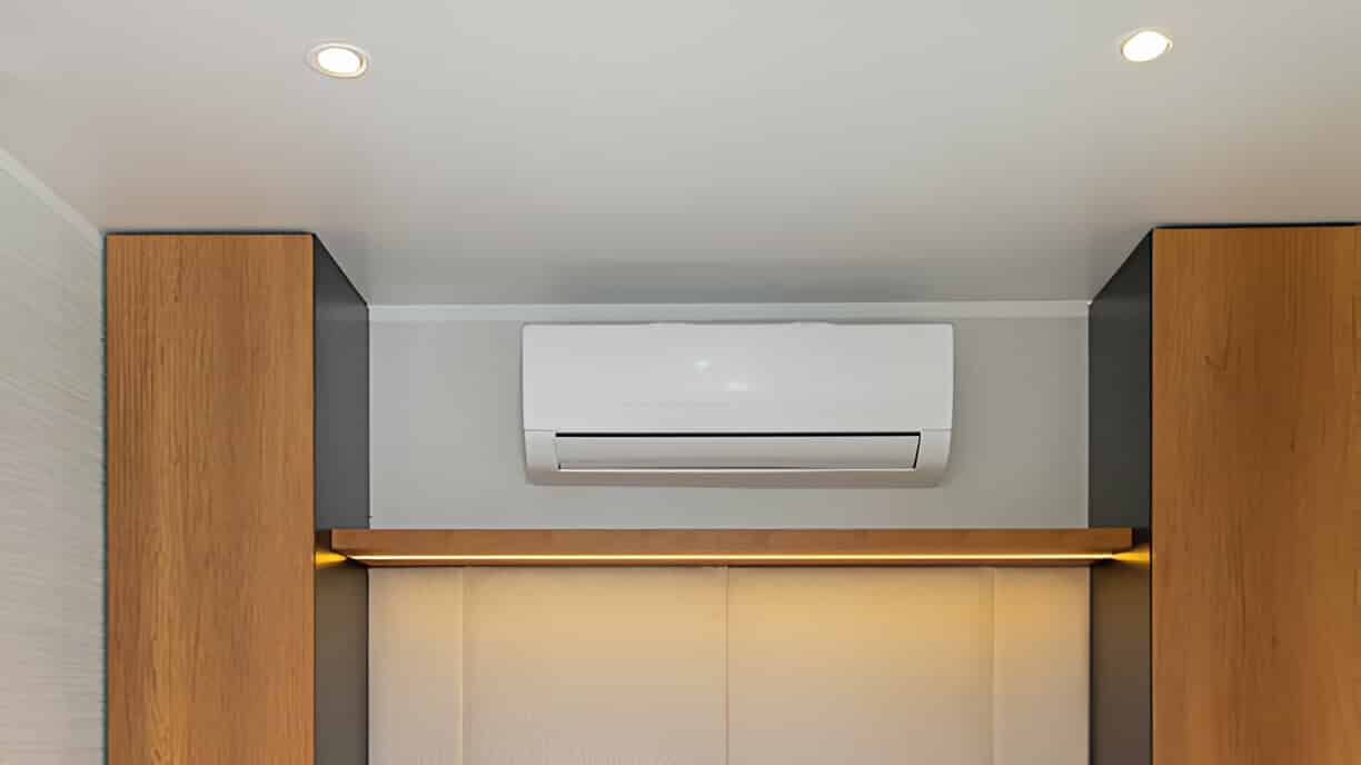 Wall-mounted air conditioner between wooden panels with recessed lighting