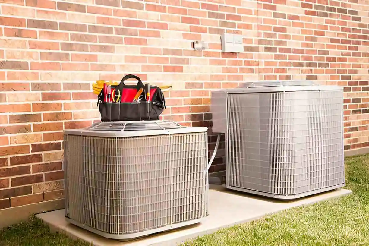 HVAC units with tool bag on brick wall background