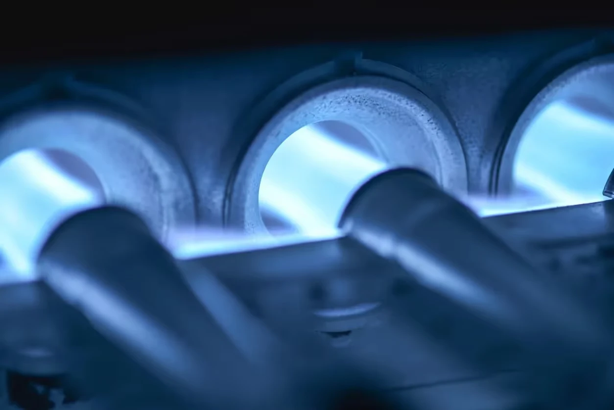 Blue-tinted curved industrial pipes or mechanical components in close-up