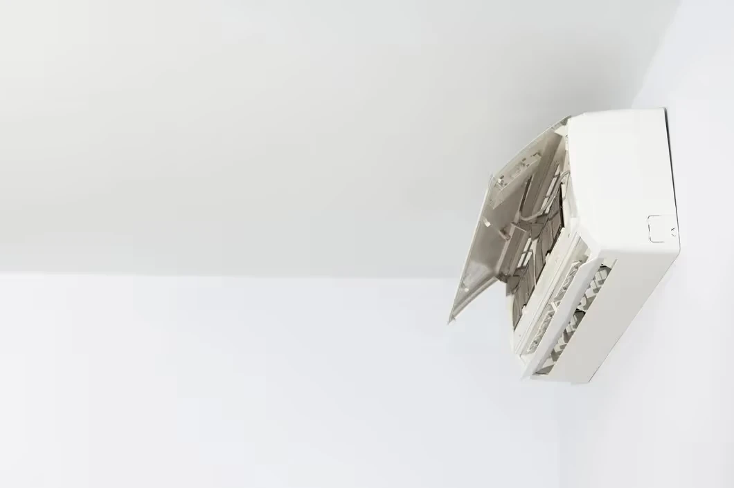 White air conditioning unit mounted on a light-colored wall