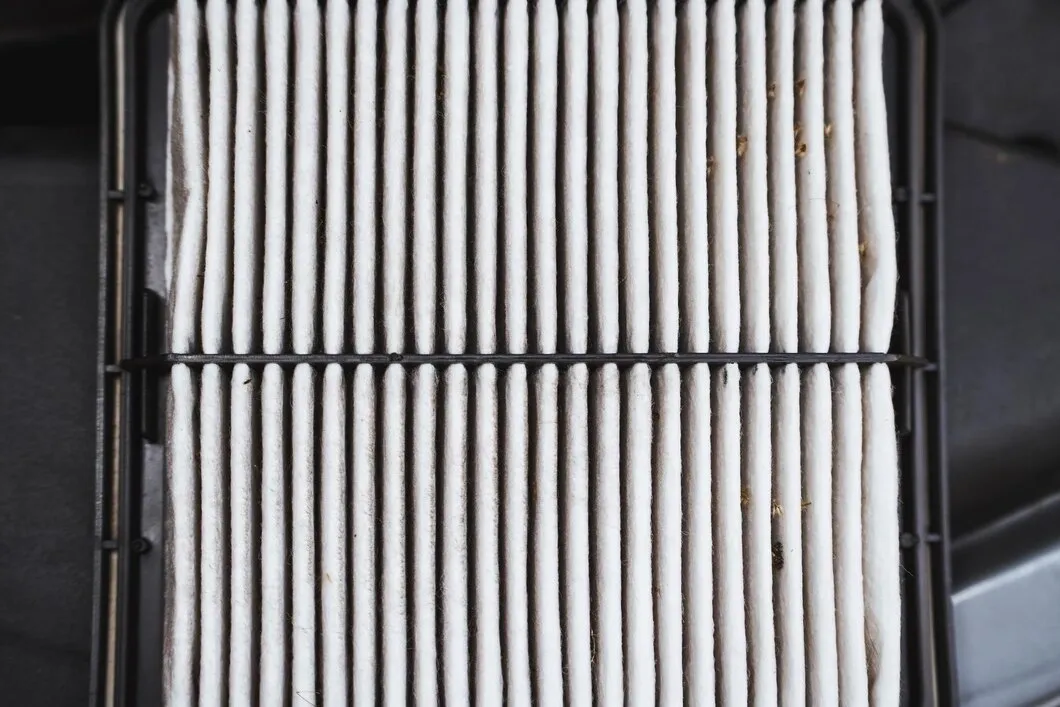  Close-up of a clean air filter with vertical pleats.