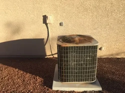 Outdoor air conditioning unit on concrete pad with electrical connection