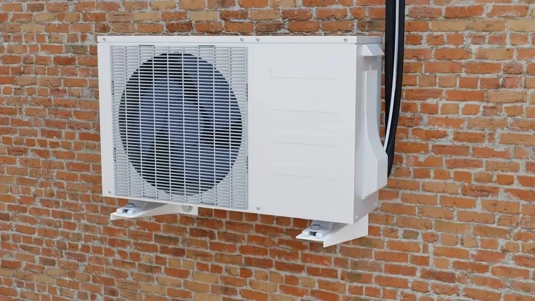 White air conditioning unit mounted on a rustic brick wall exterior