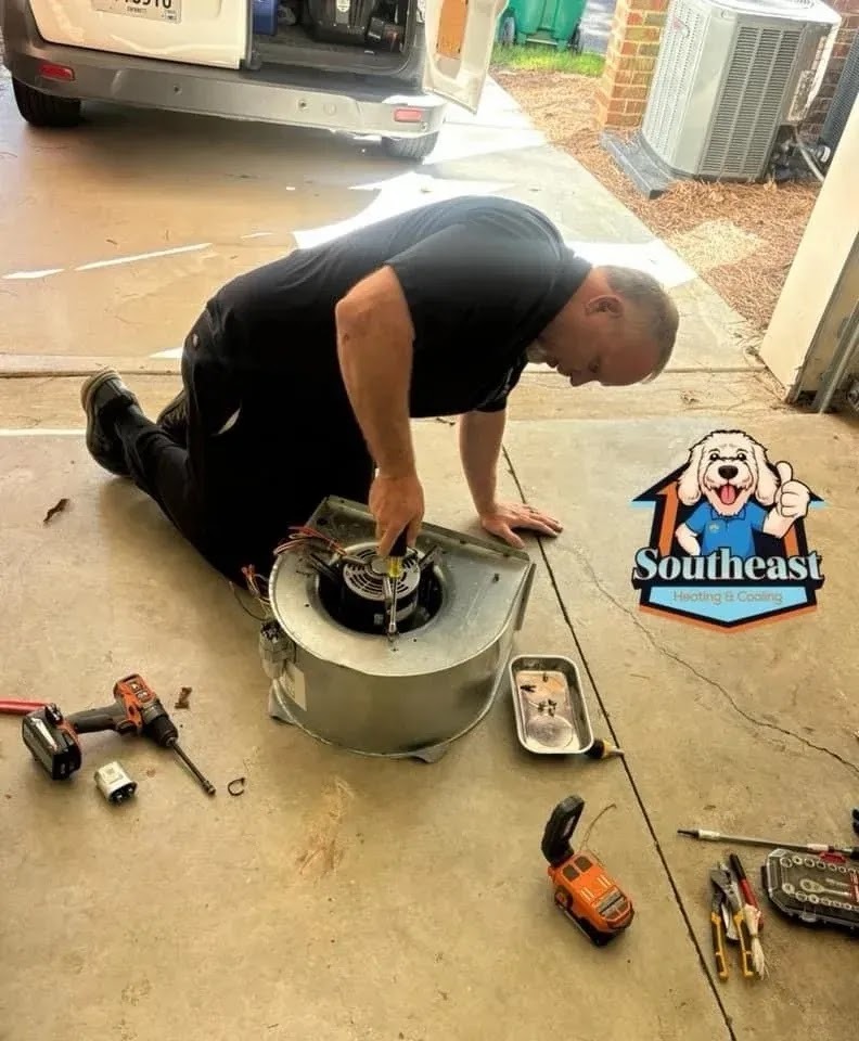 Technician performing spring maintenance on an air conditioning unit in a sunny backyard