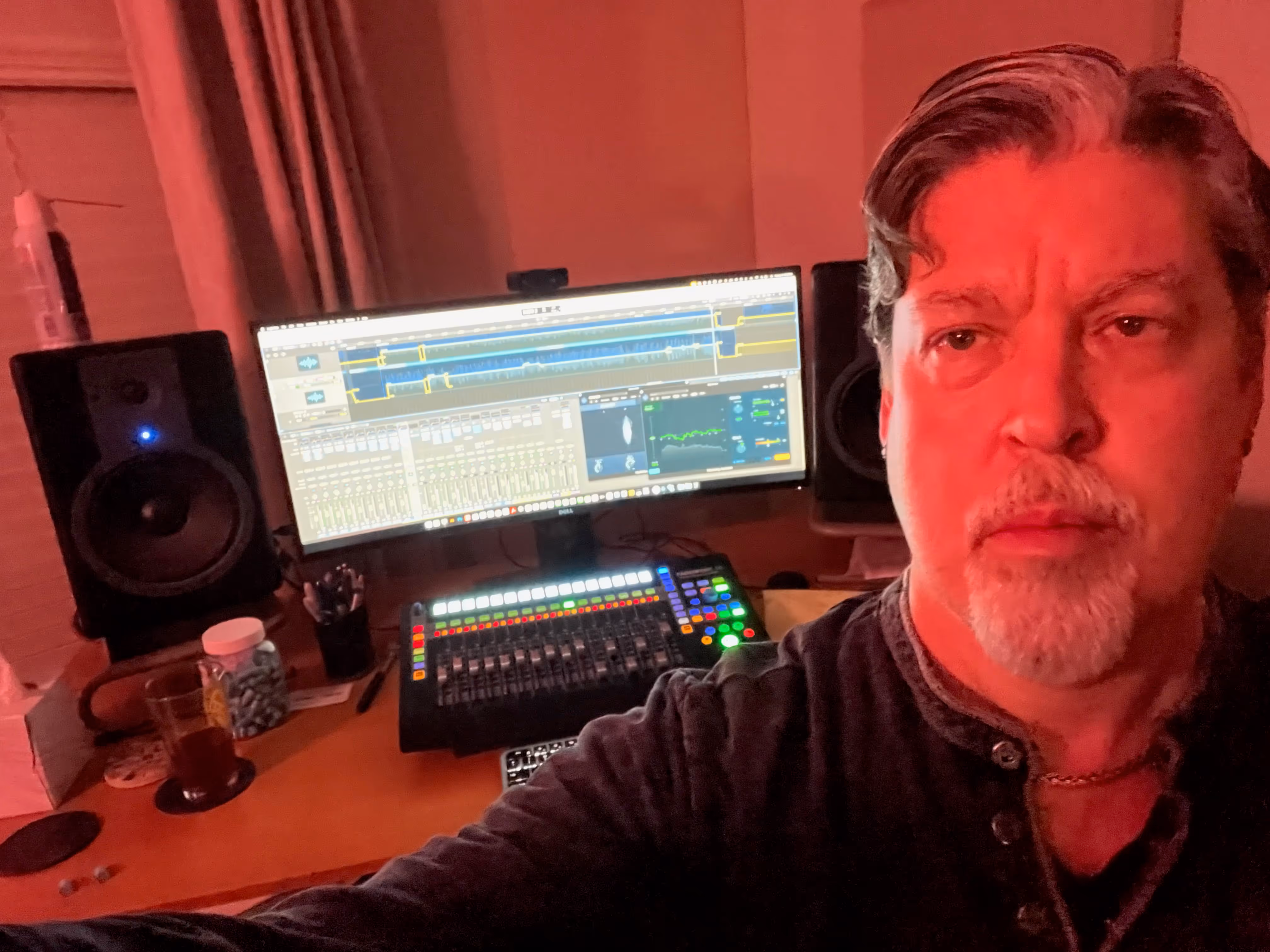 A photo of Phil Hodges at his audio production desk.