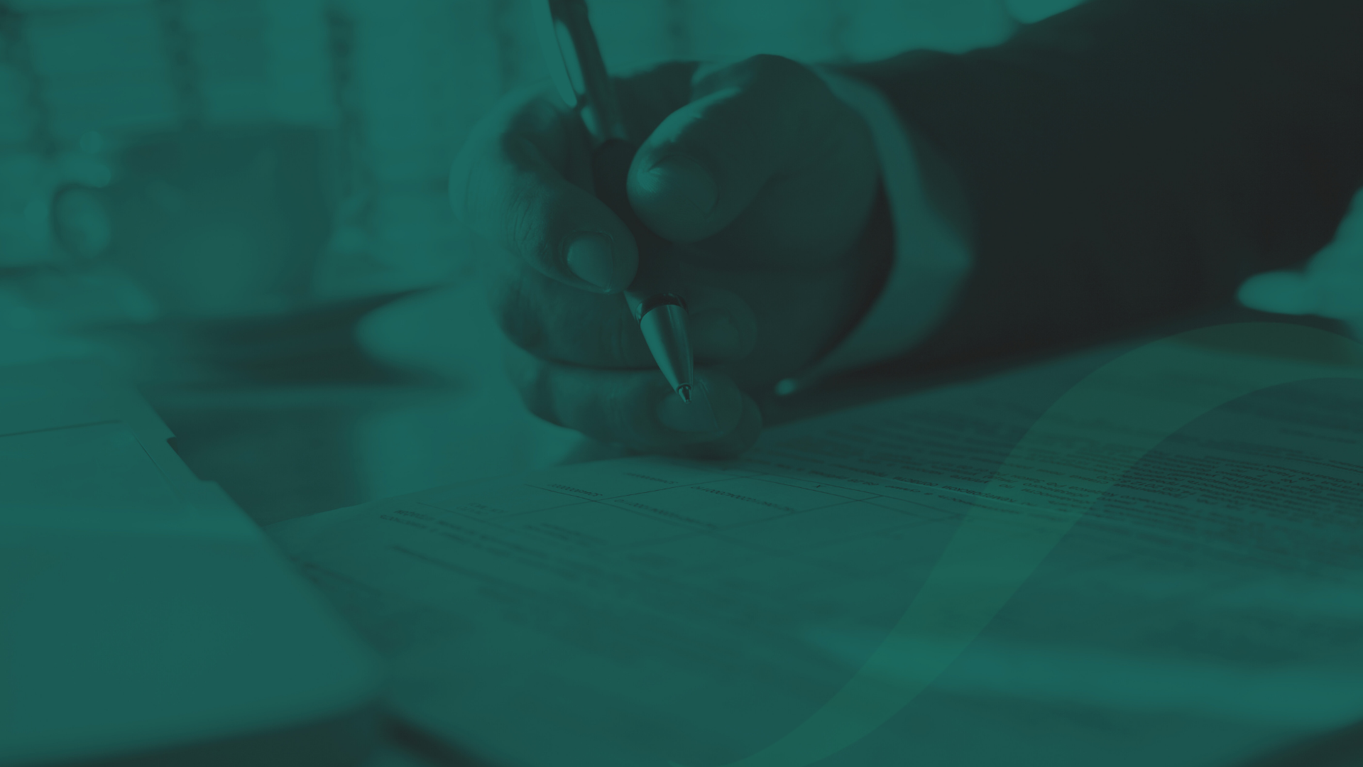 A hand working through papers as if checking compliance.