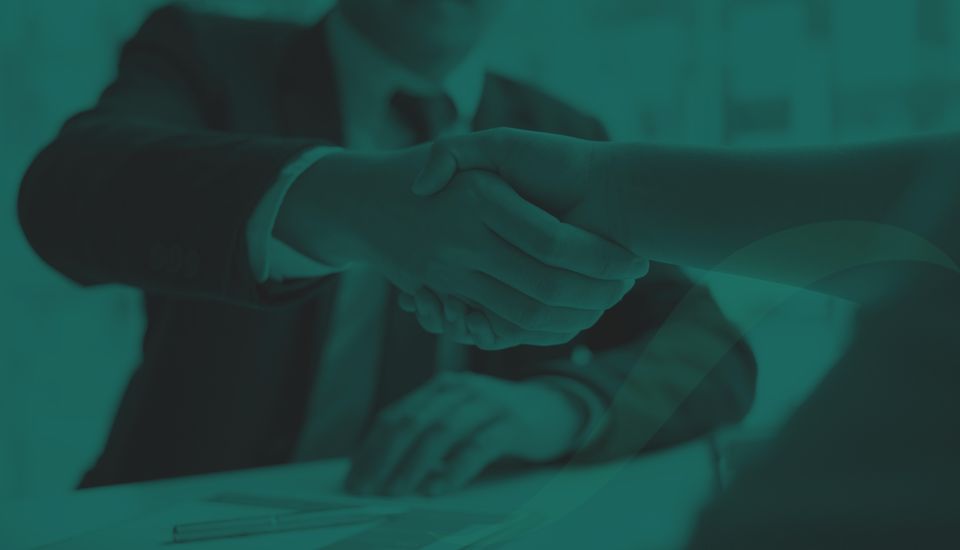 Two people shaking hands symbolising an employee agreeing to an employment contract.