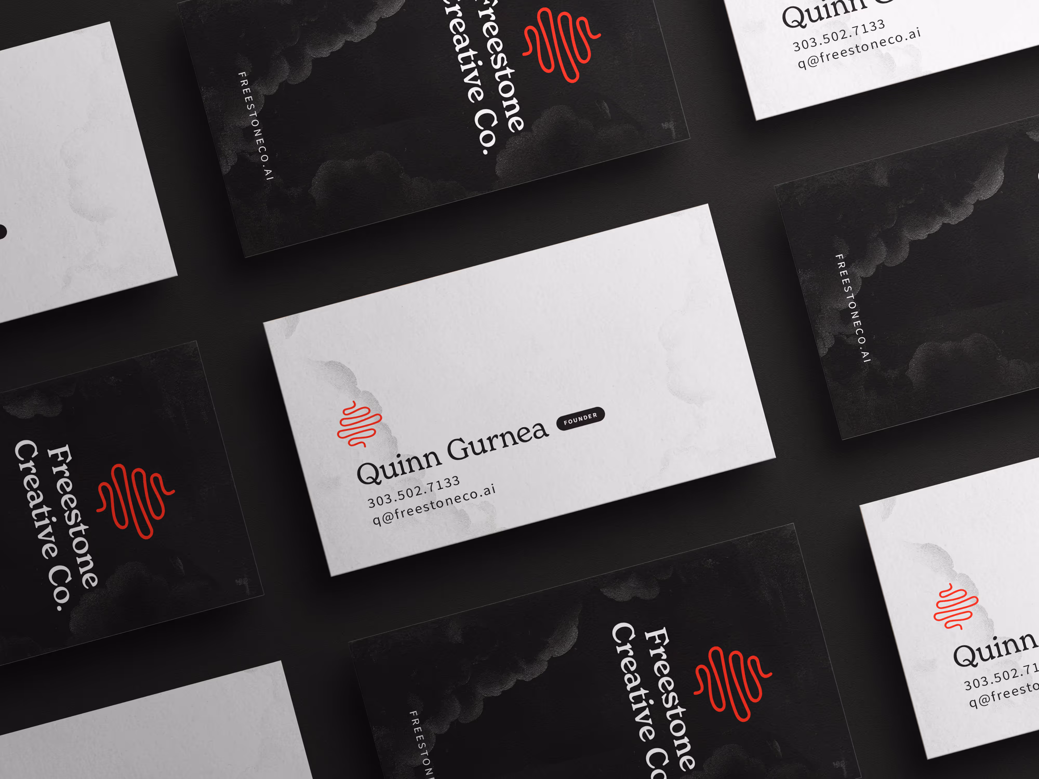 Freestone Creative Co. branded business cards with the founders contact information. Black and white with a red squiggle.