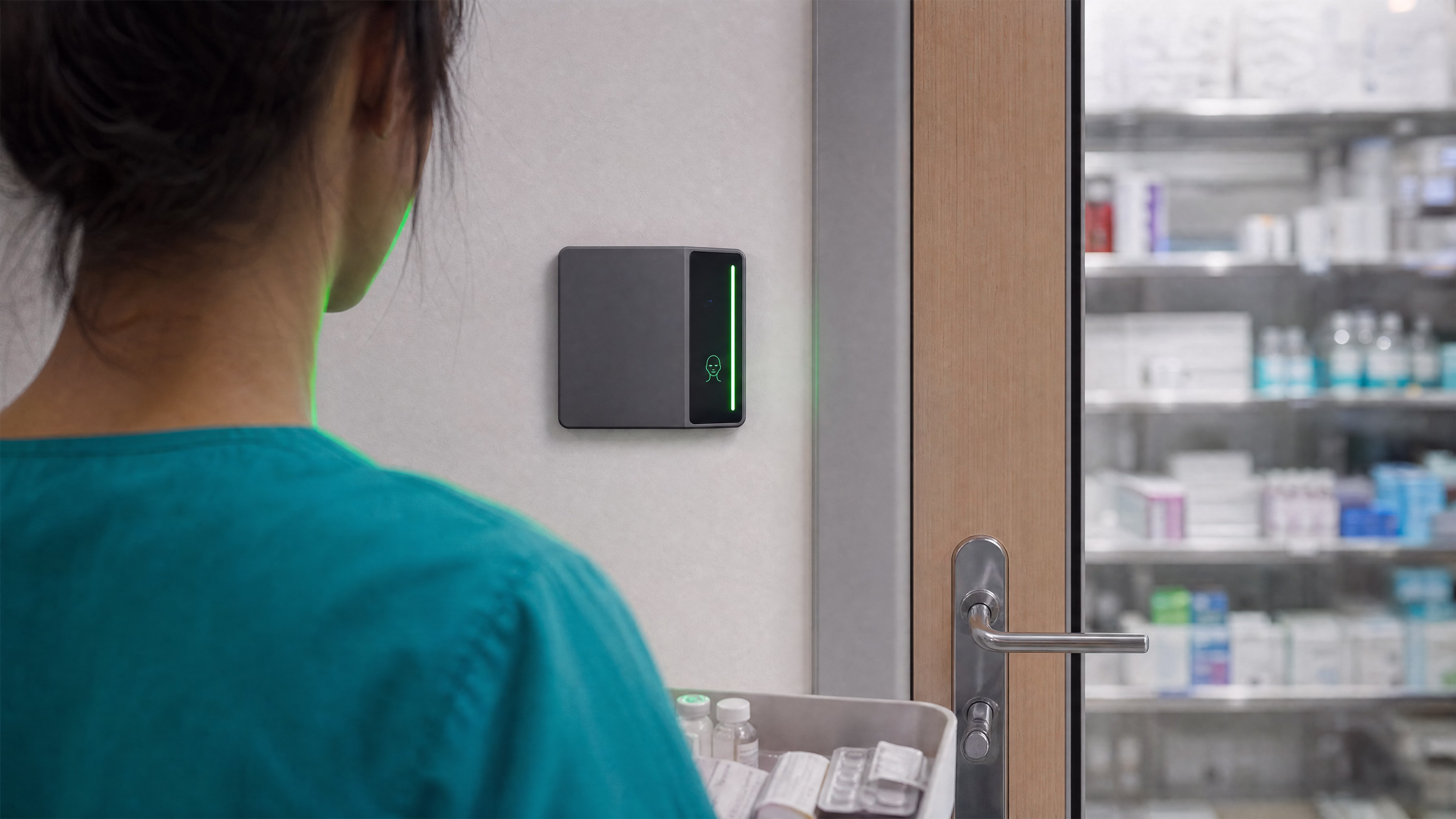 A clinician with a medication tray authenticating at a pharmacy door, the Rock X light bar green