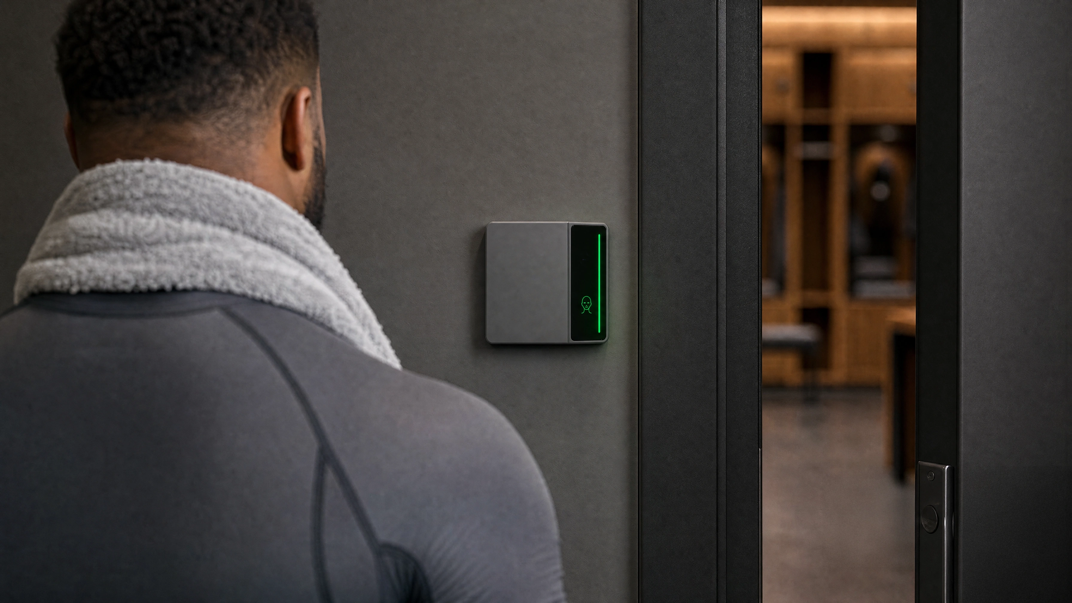 An athlete walking up to a locker room door as the Rock reader beside it turns green