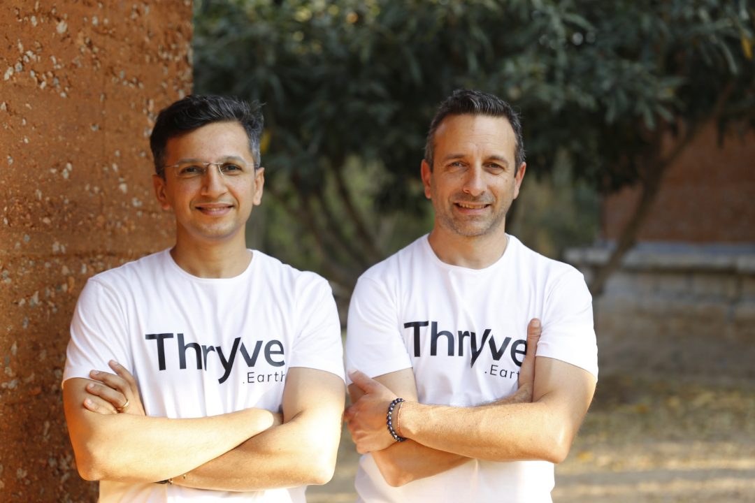 Thryve.Earth co-founders posing together wearing Thryve branded t-shirts
