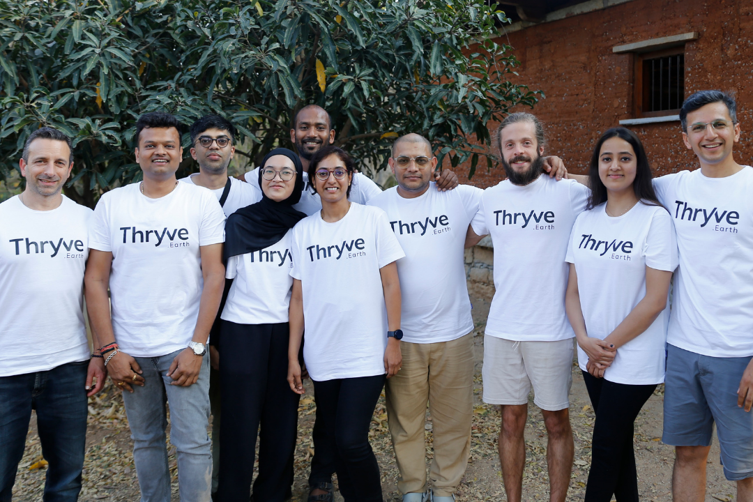 Thryve.Earth team members posing together as a group wearing Thryve branded t-shirts