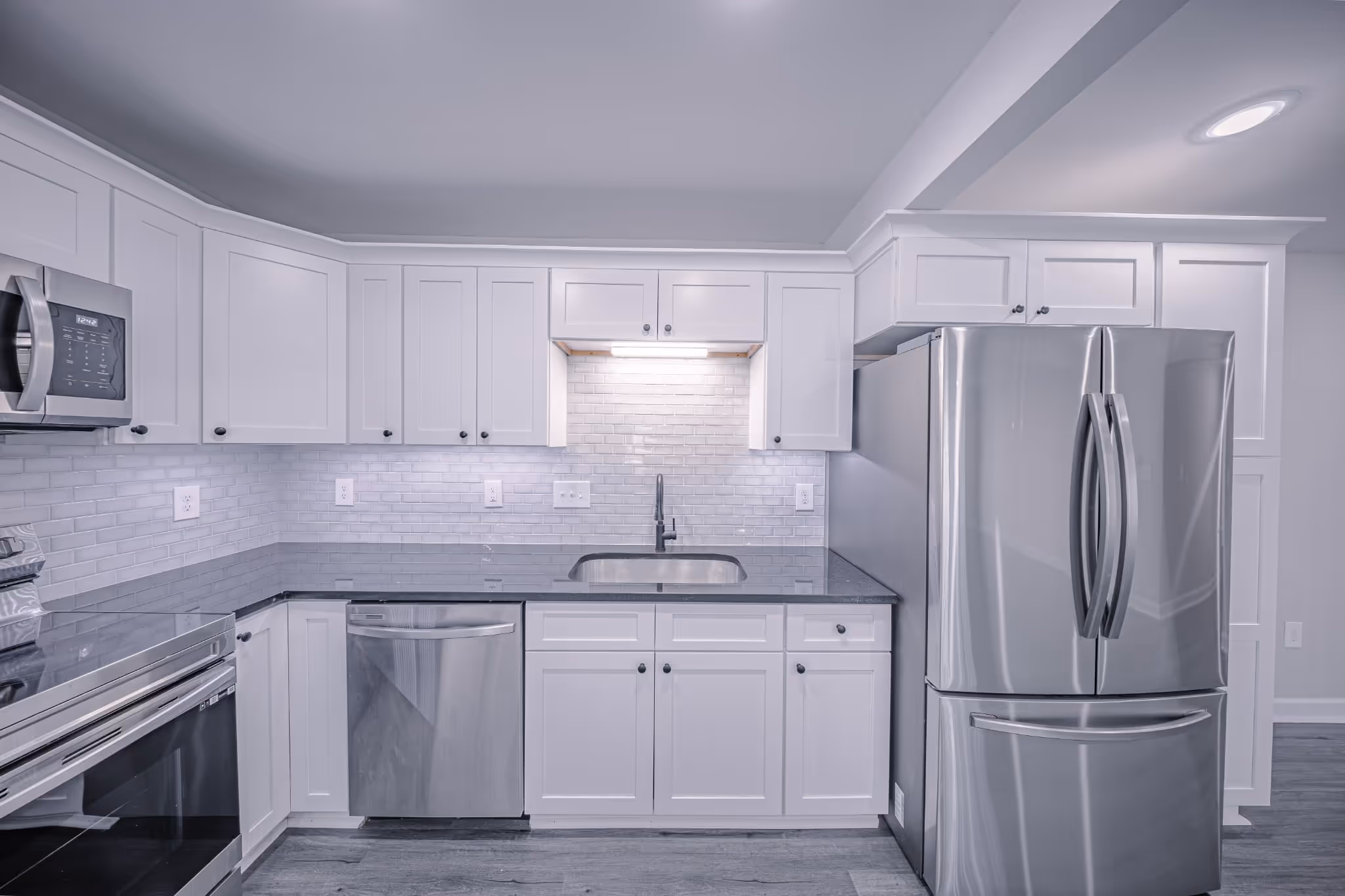 Sleek kitchen with white cabinetry at Apex apartment in Marietta GA