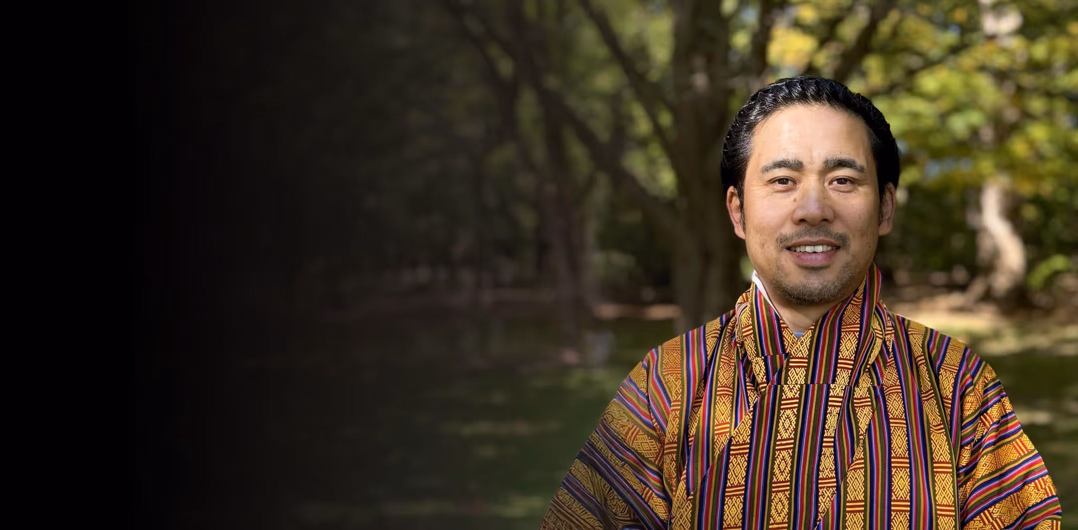 Deepak Tamang, founder of Raven Tours Bhutan, in traditional attire, welcoming guests to soulful Bhutan travel experiences.
