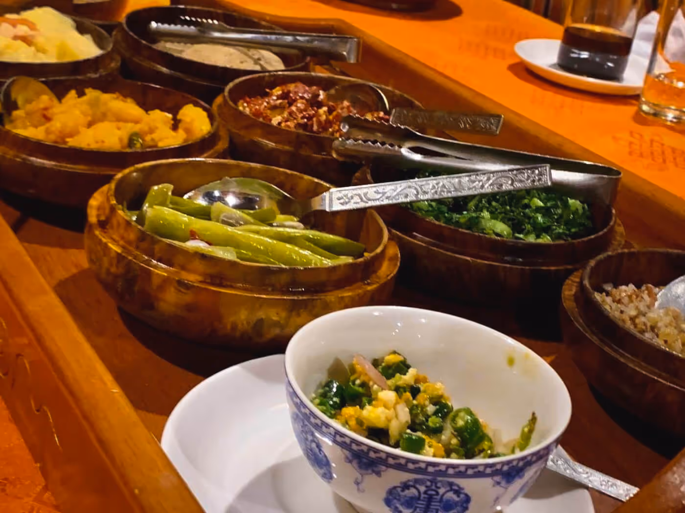 A colourful spread of traditional Bhutanese dishes—spicy, hearty, and locally sourced—invites guests to savour Bhutan’s bold, earthy flavours.