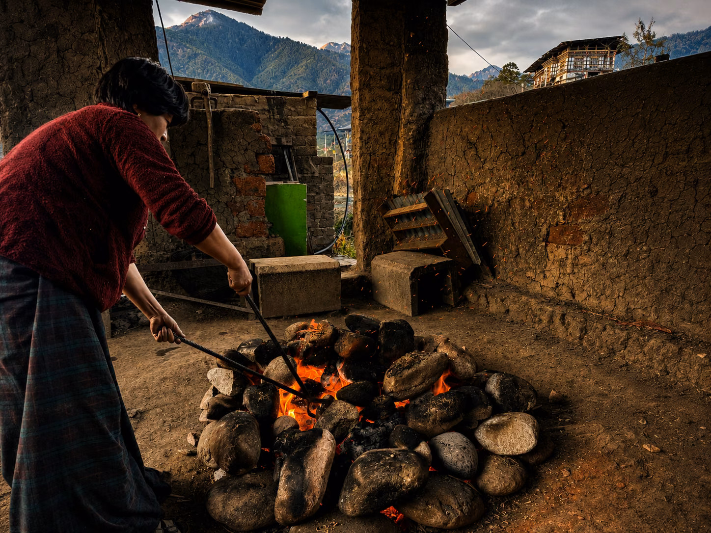 River stones heating over a wood fire for a traditional Bhutanese hot stone bath.