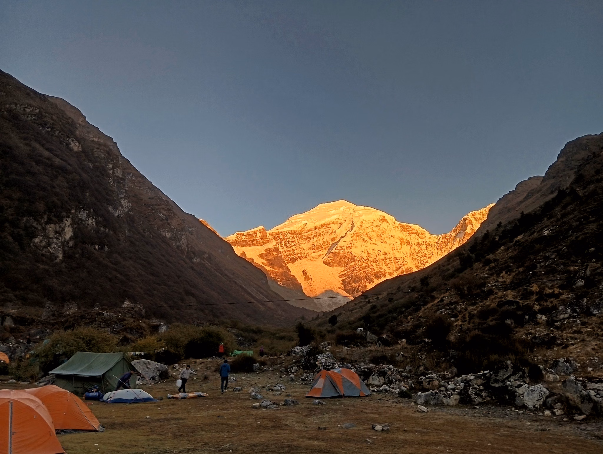 Supported trekking camp beneath snow-covered Jomolhari in early morning light, Bhutan.