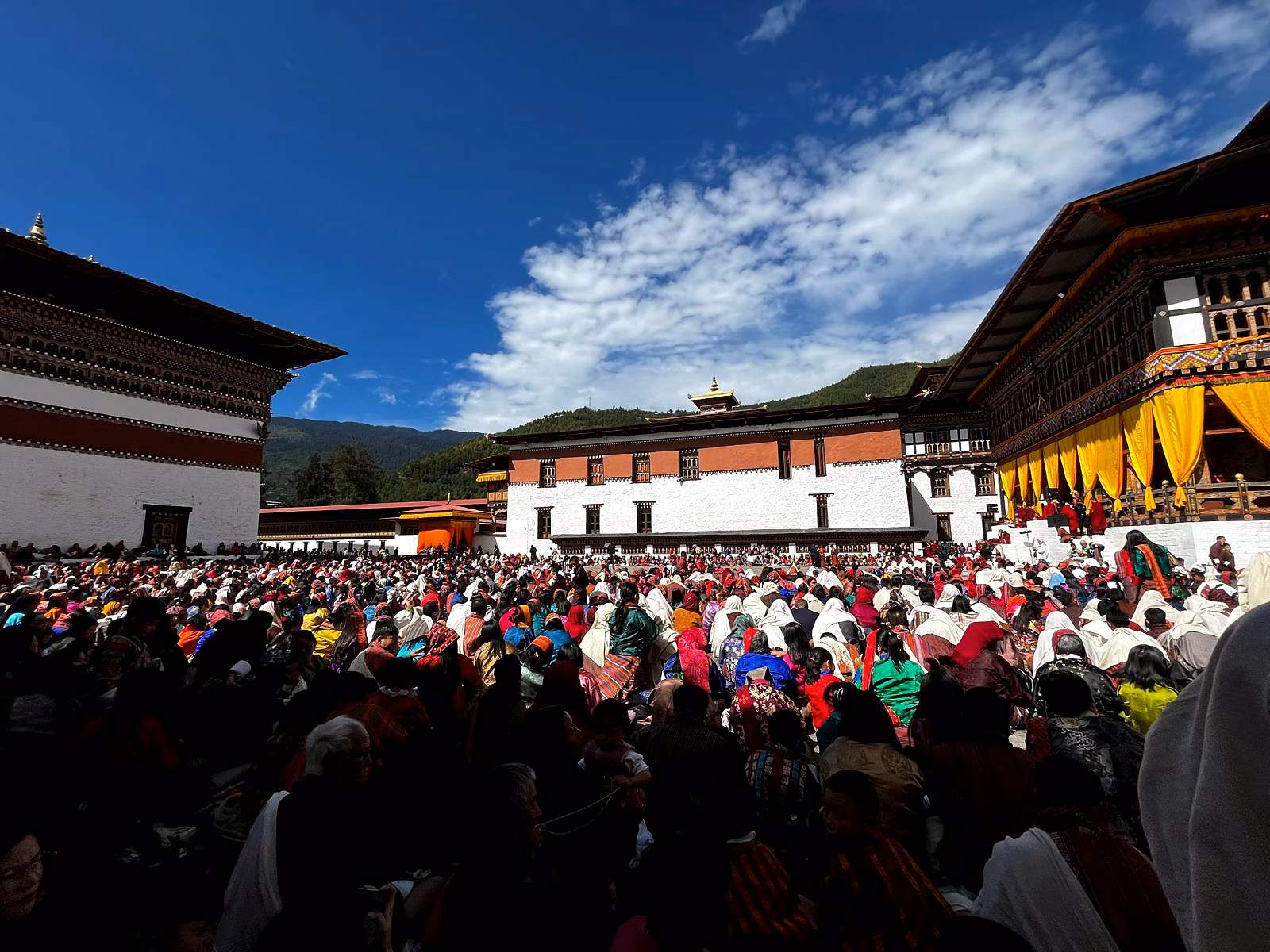 Festivalgoers gather in a monastery courtyard during a Bhutanese tshechu.
