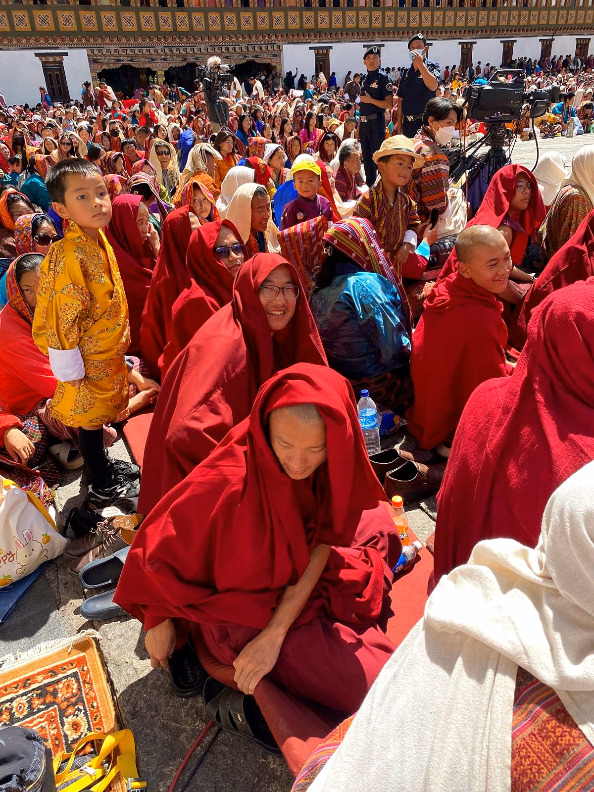 Monks, families and children gather together during a Bhutanese tshechu festival.