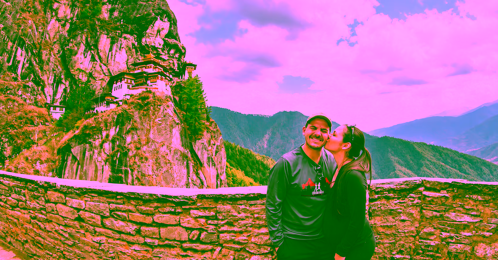 A couple shares a moment at the viewpoint overlooking Tiger’s Nest Monastery in Paro, Bhutan.
