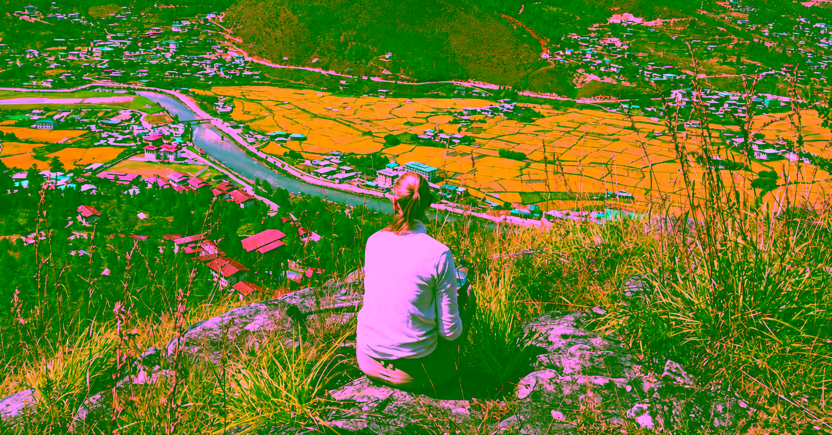 A guest enjoys a quiet moment overlooking the river and terraced fields of Paro Valley, Bhutan.