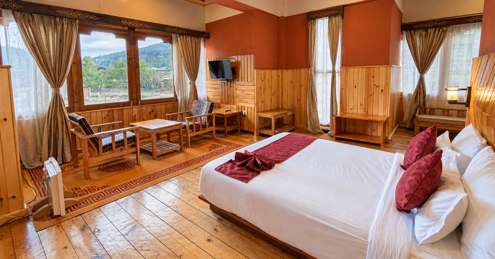 Timber-lined guest room with a seating area and mountain views at Eco Nest Resort in Paro, Bhutan