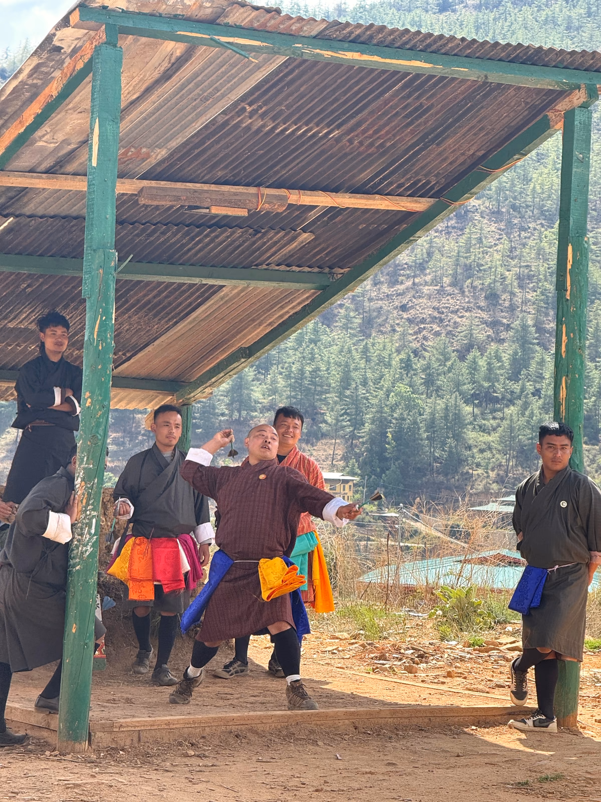 People gathered around an outdoor game of khuru.