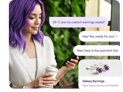 A woman with vibrant purple hair and a white blazer holds a coffee cup and looks at her phone while smiling. On the right, a chat conversation shows her asking if her custom earrings are ready. The response confirms they are ready and includes a payment link with an image of silver earrings featuring purple gemstones labeled "Galaxy Earrings."
