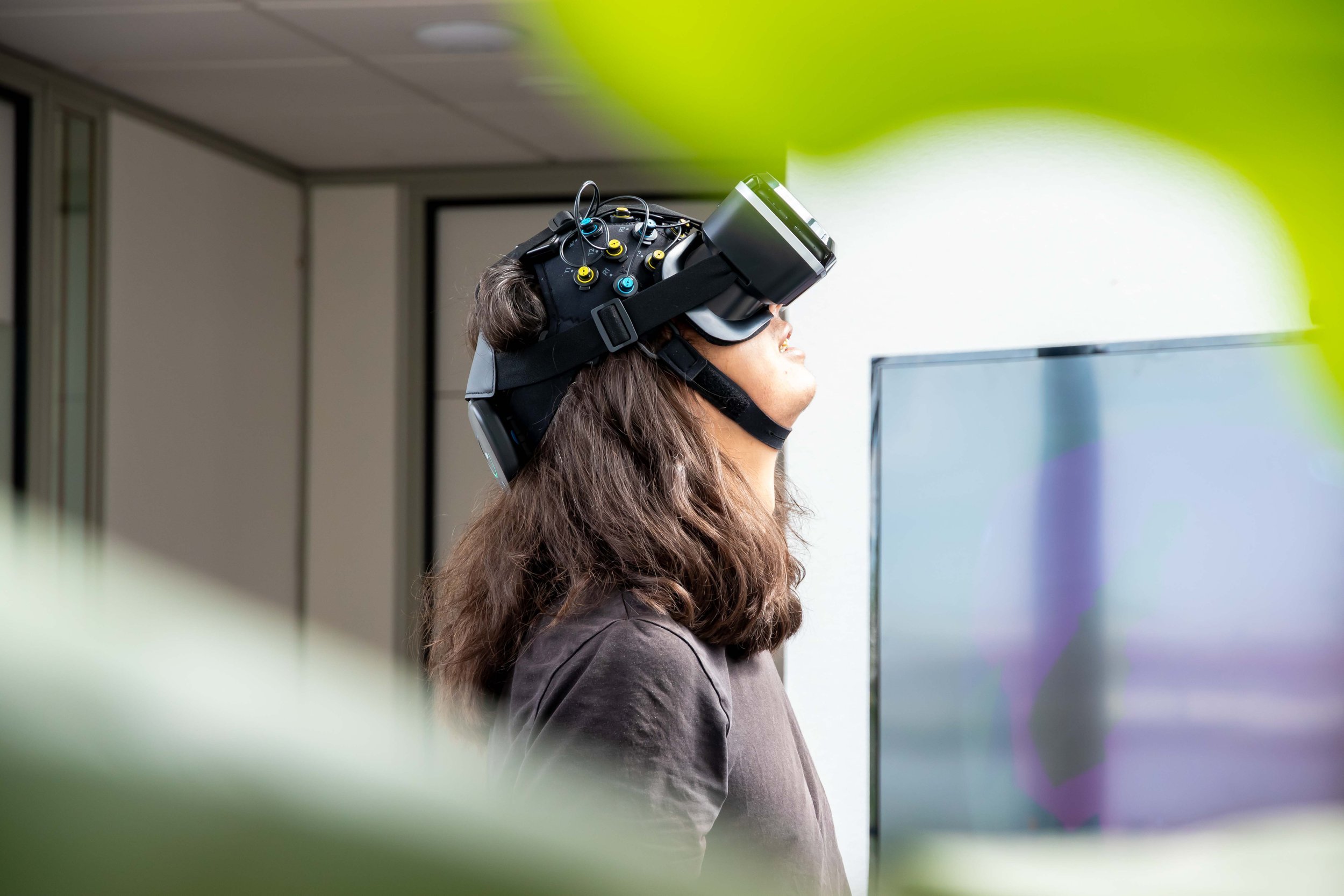 Man wearing an Artinis Brite Frontal headband with a VR headset