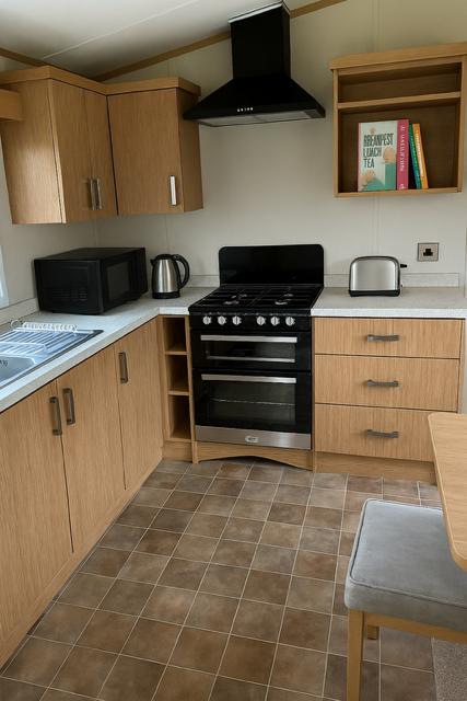 Modern kitchen with wooden cabinets, black appliances, and tiled floor