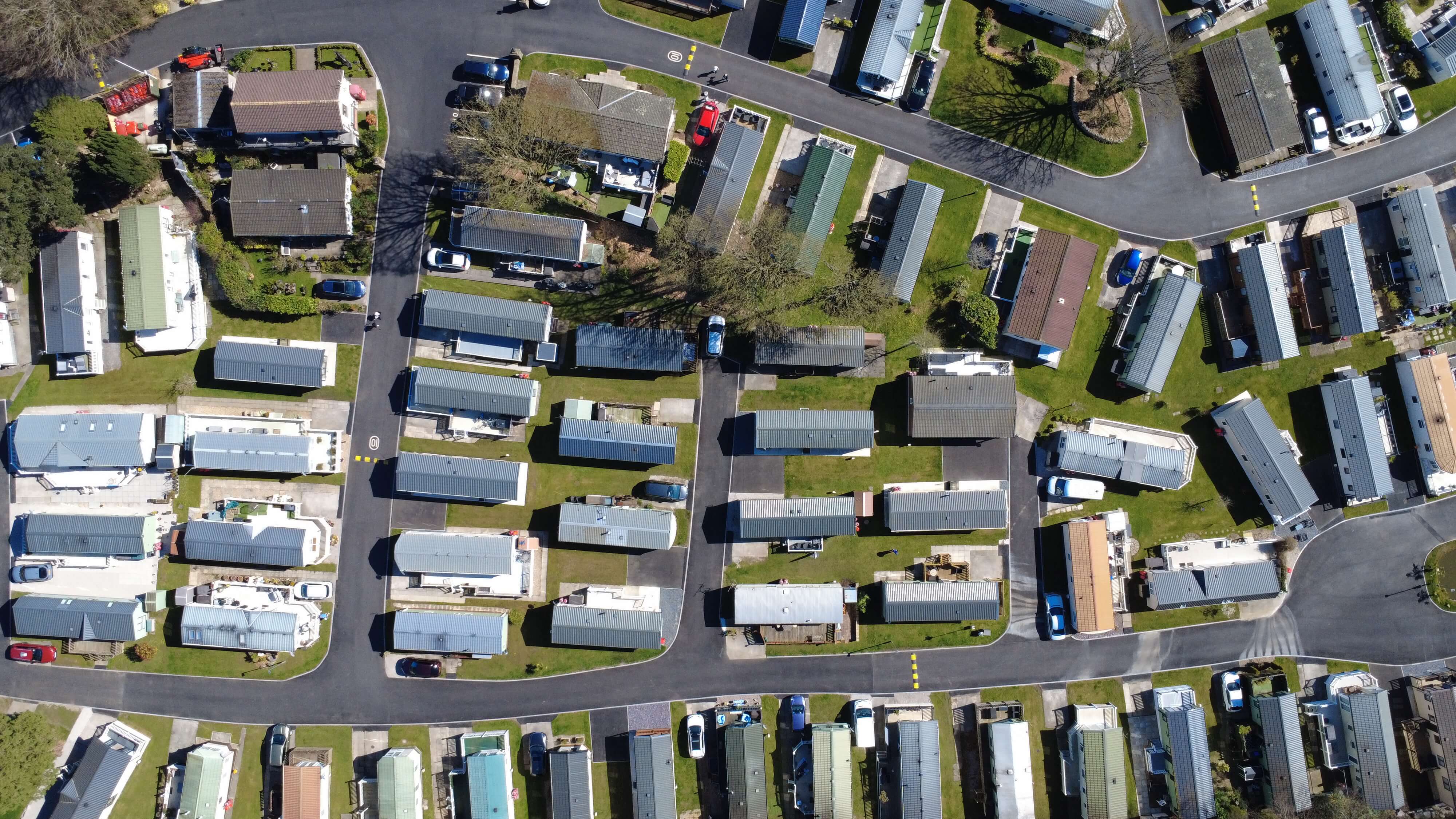 Aerial view of mobile home park with rows of trailers and winding streets