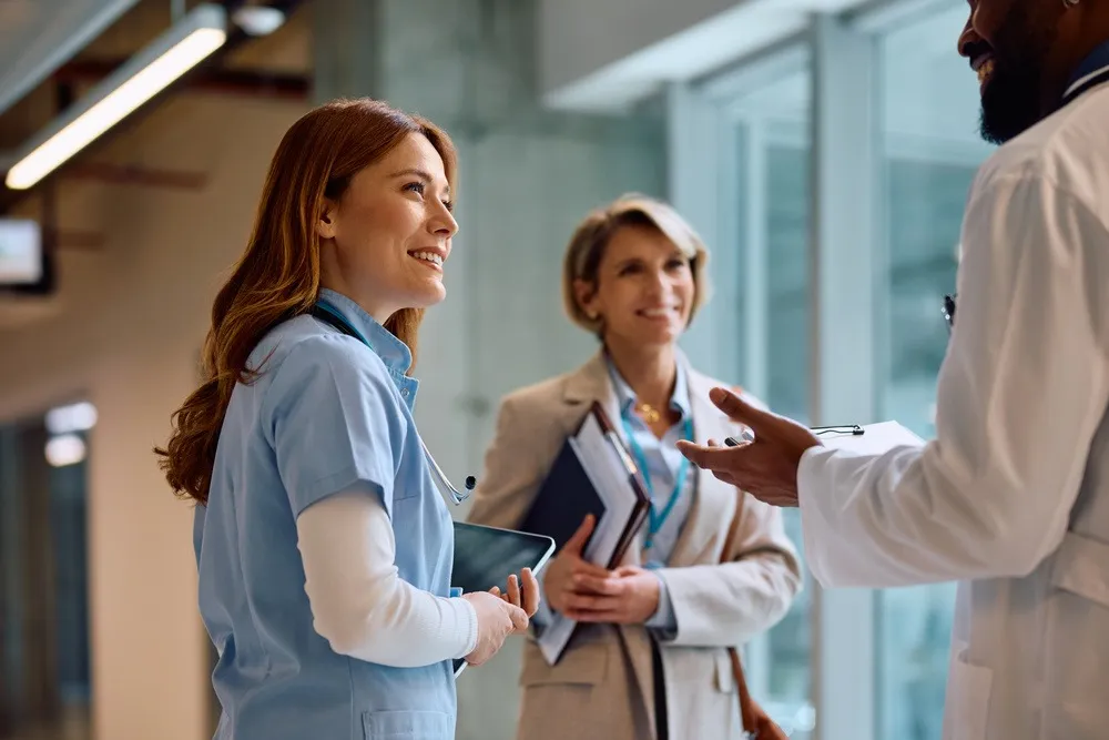 A group of doctors standing around talking to each other.