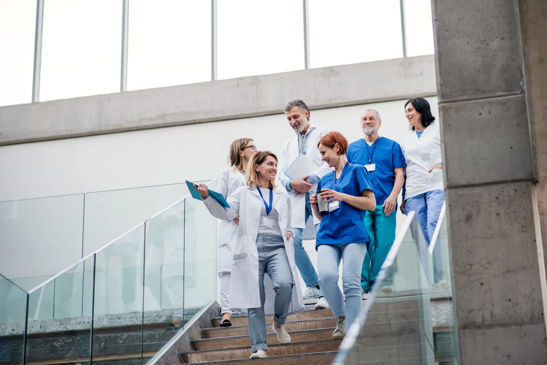 A group of doctors walking down a flight of stairs.