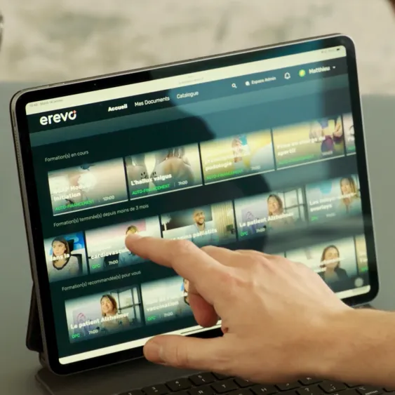 A person's hand is touching the screen of a laptop.