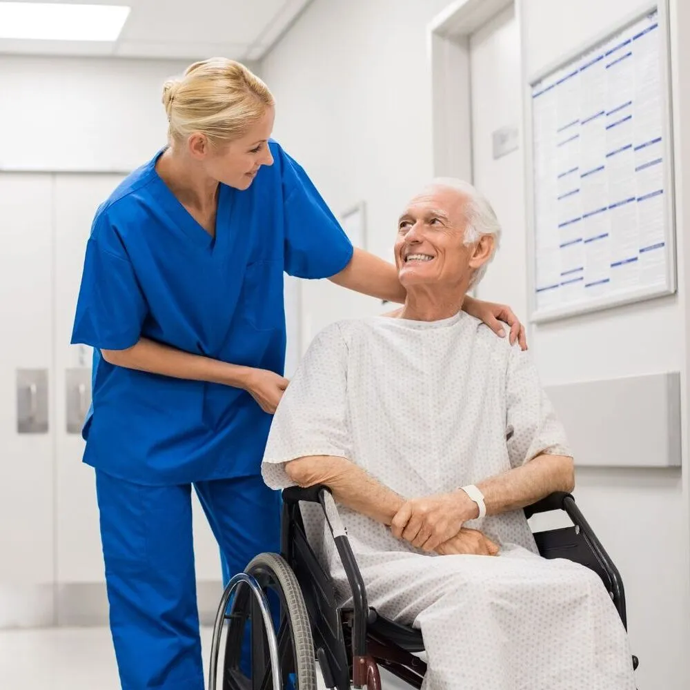 A nurse helping a patient in a wheelchair.