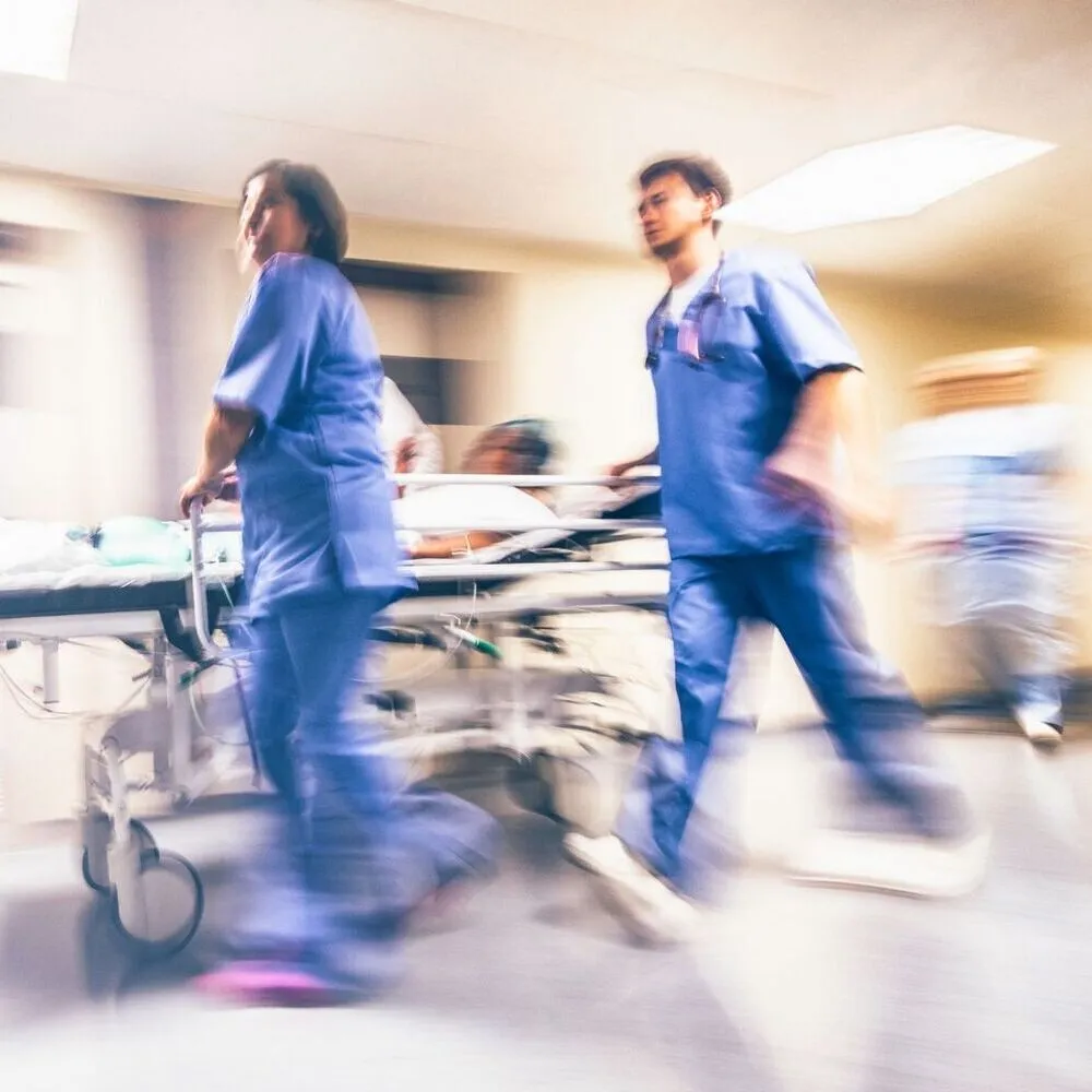 A couple of doctors walking down a hospital hallway.
