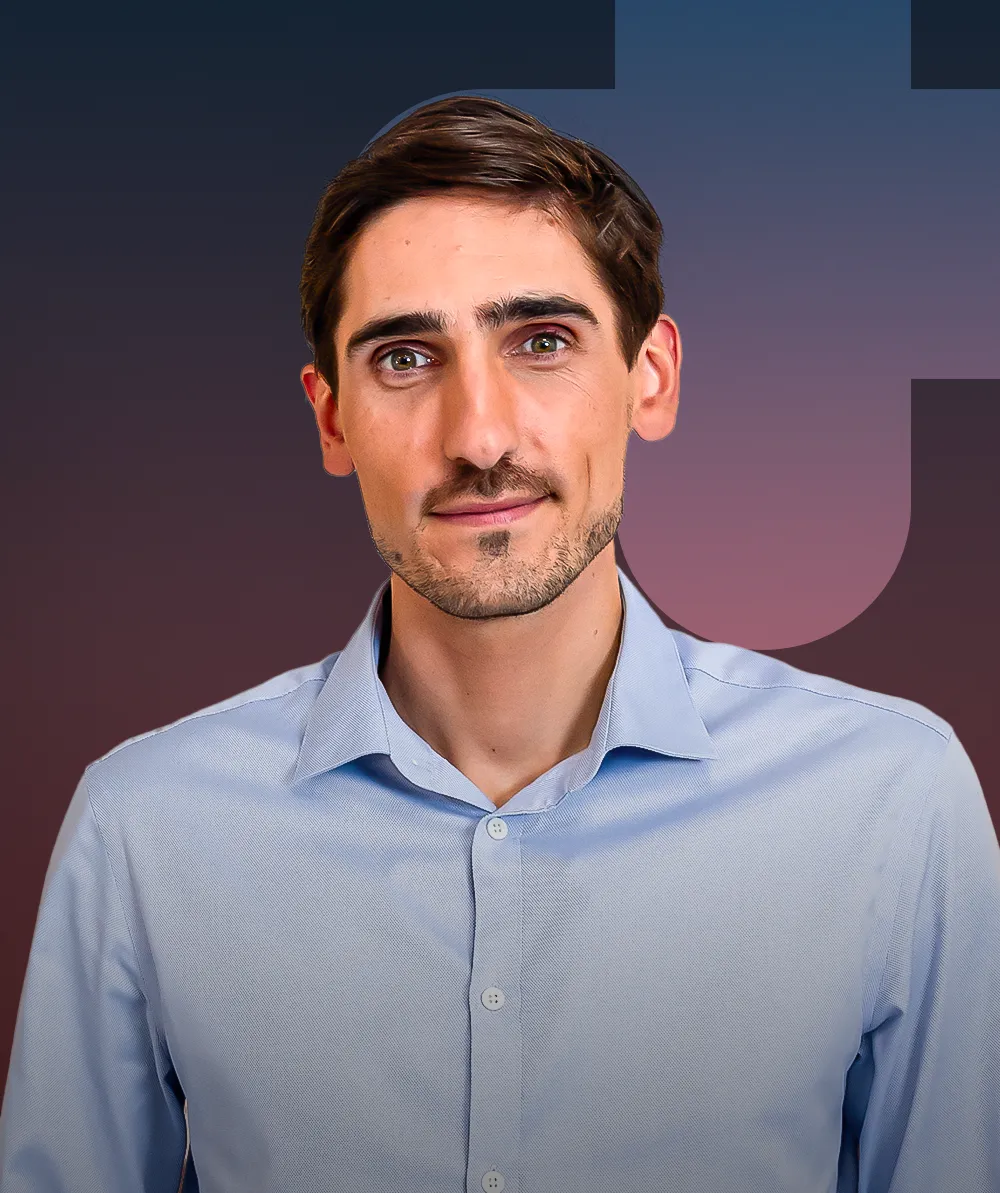 A man with a mustache and a blue shirt.