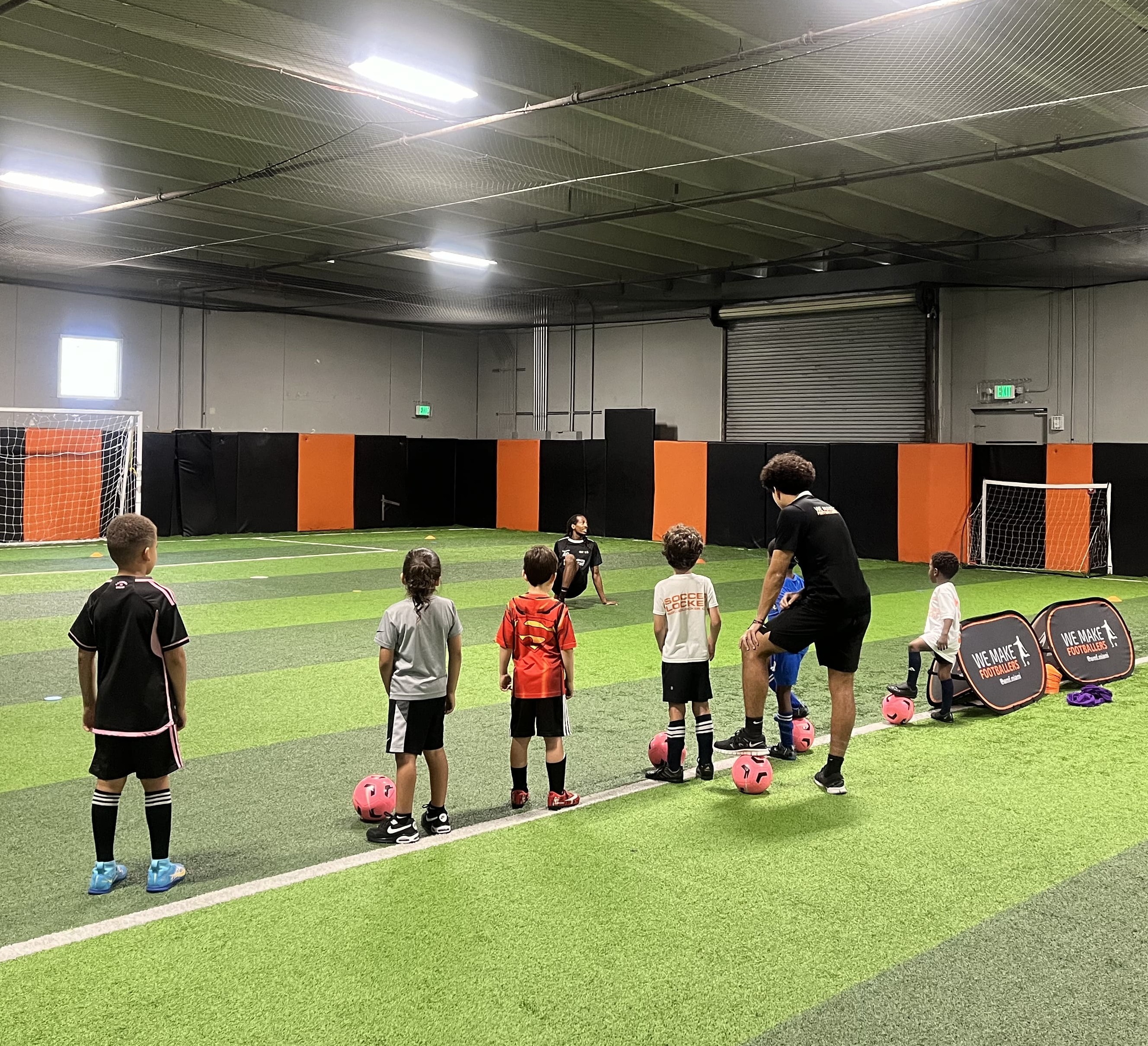 Children building friendships and teamwork skills on a soccer field.