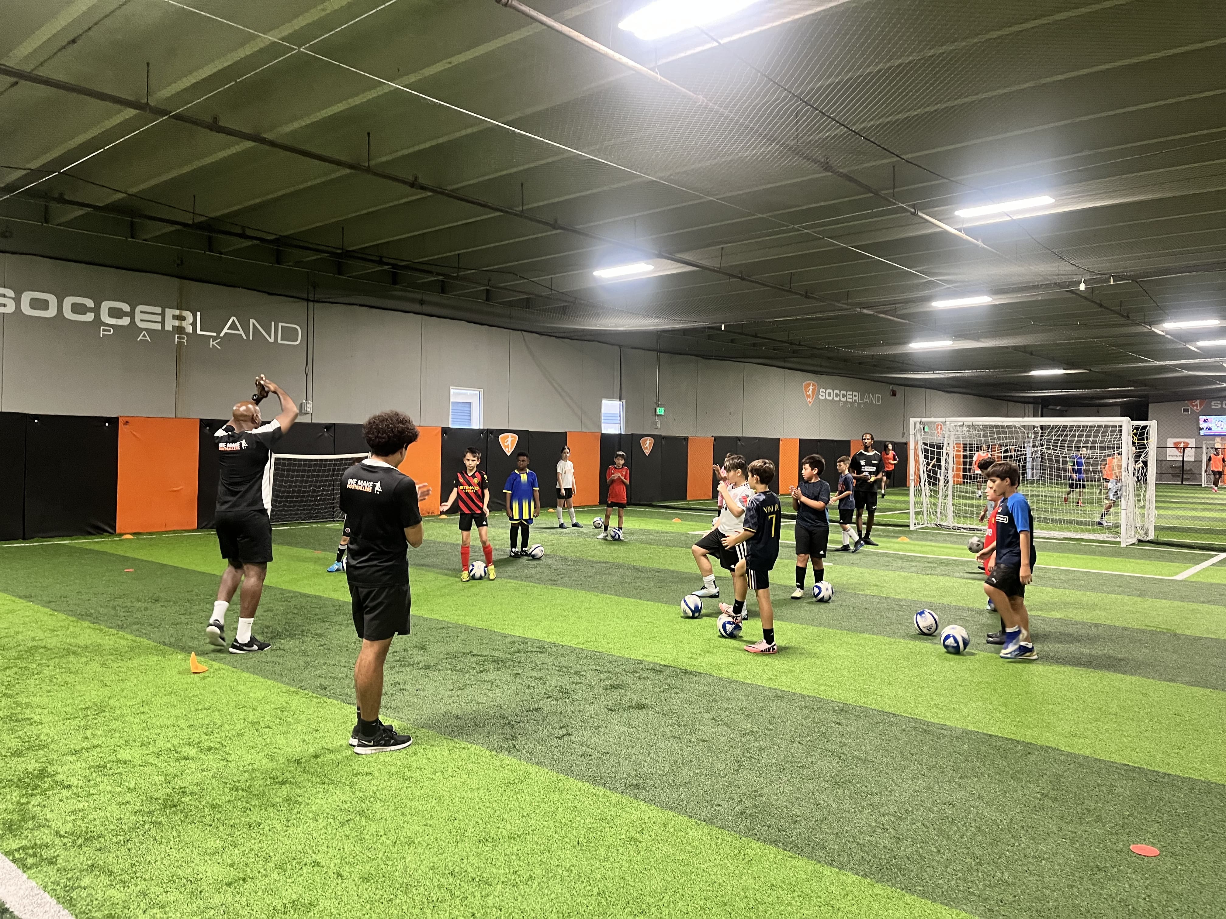 Young players building cooperation and focus while learning soccer skills together.