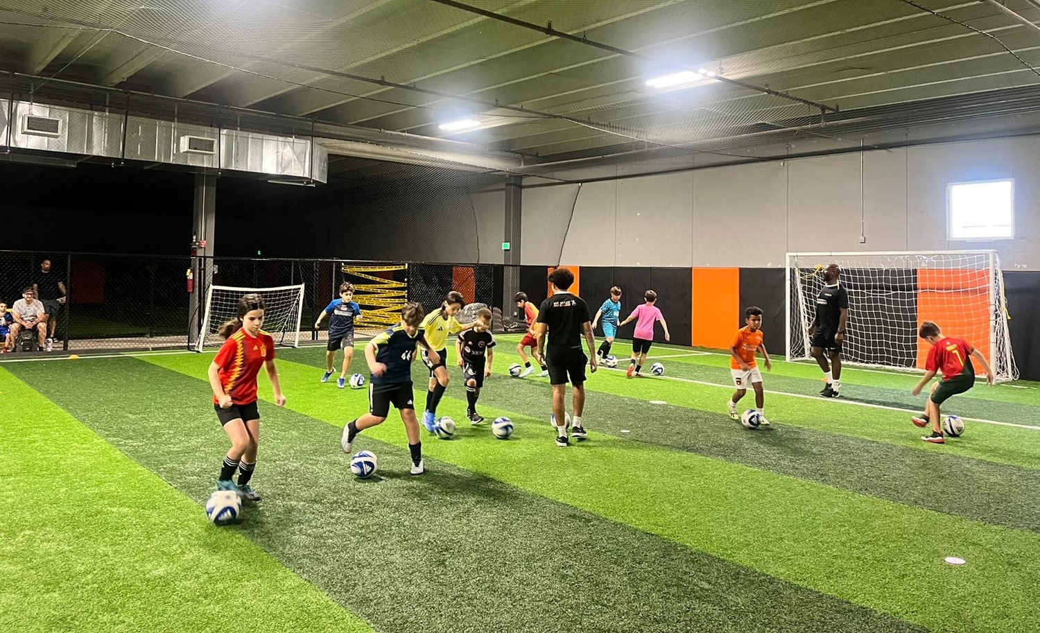 Kids smiling and running during soccer practice, enjoying active play.