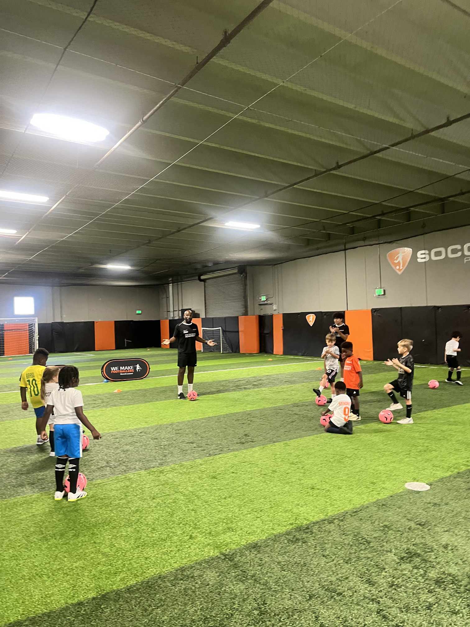 Child building confidence through soccer in a fun setting