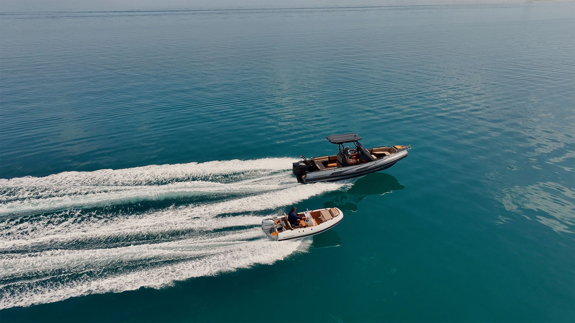 Small and big RIB boats with unique modern design sailing across pacific ocean. Compare of two Aluminum Rigid Inflatable Boats models size Aquaspirit S700 and S370